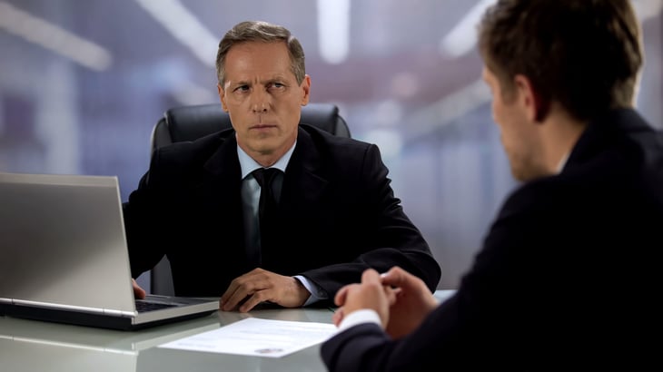 Suspicious hiring manager or businessman interviewing a lying job candidate with lies on his resume