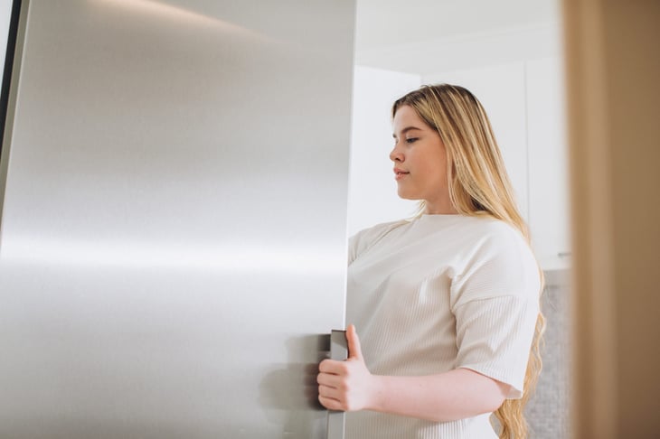 Woman looking in fridge for something to eat