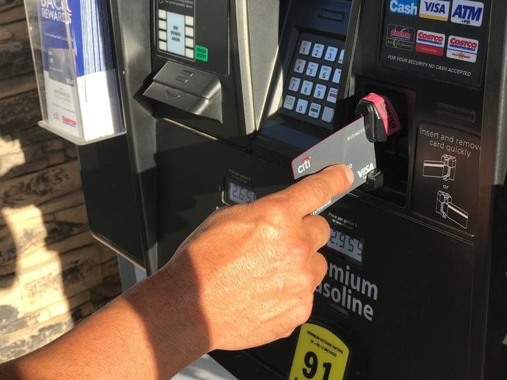 A Costco member using a credit card at a gas pump
